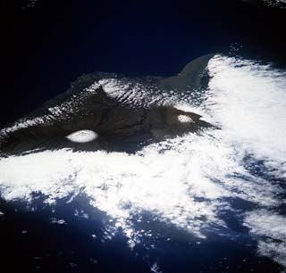 Winter view of the Big island of Hawaii, with light snowcapped peaks of Mauna Kea and Mauna Loa.